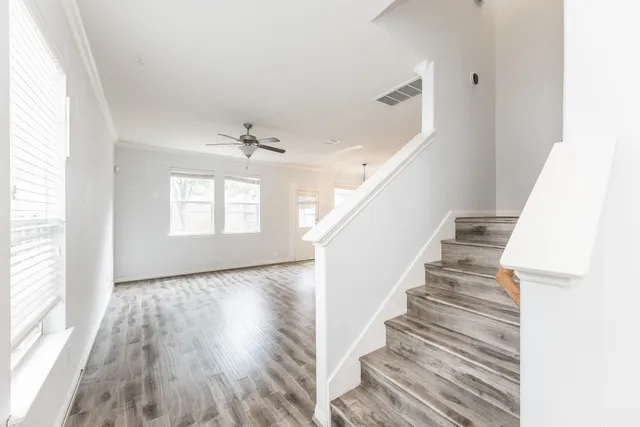 a view of entryway and hall with wooden floor