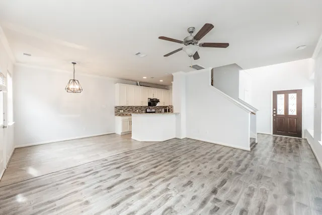 a view of a kitchen with a sink and a refrigerator