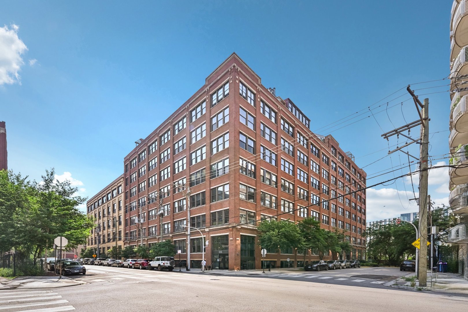 a view of a tall building next to a road