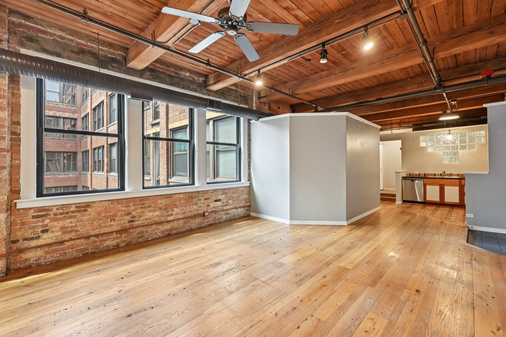 913 West Van Buren Street, Unit 5H Chicago, IL 60607 - Photo 12 of 23 a view of an empty room with wooden floor and a window