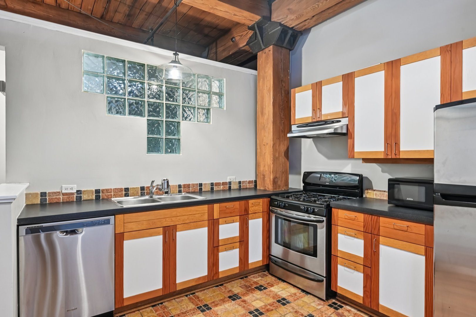 913 West Van Buren Street, Unit 5H Chicago, IL 60607 - Photo 14 of 23 a kitchen with stainless steel appliances a stove a sink and a microwave