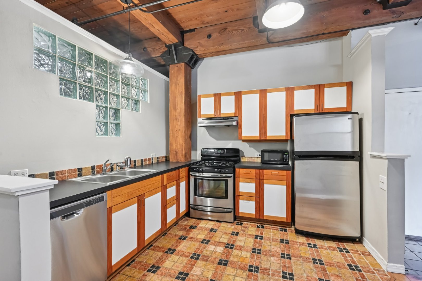 913 West Van Buren Street, Unit 5H Chicago, IL 60607 - Photo 15 of 23 a kitchen with stainless steel appliances granite countertop a refrigerator a stove and a sink with wooden floor
