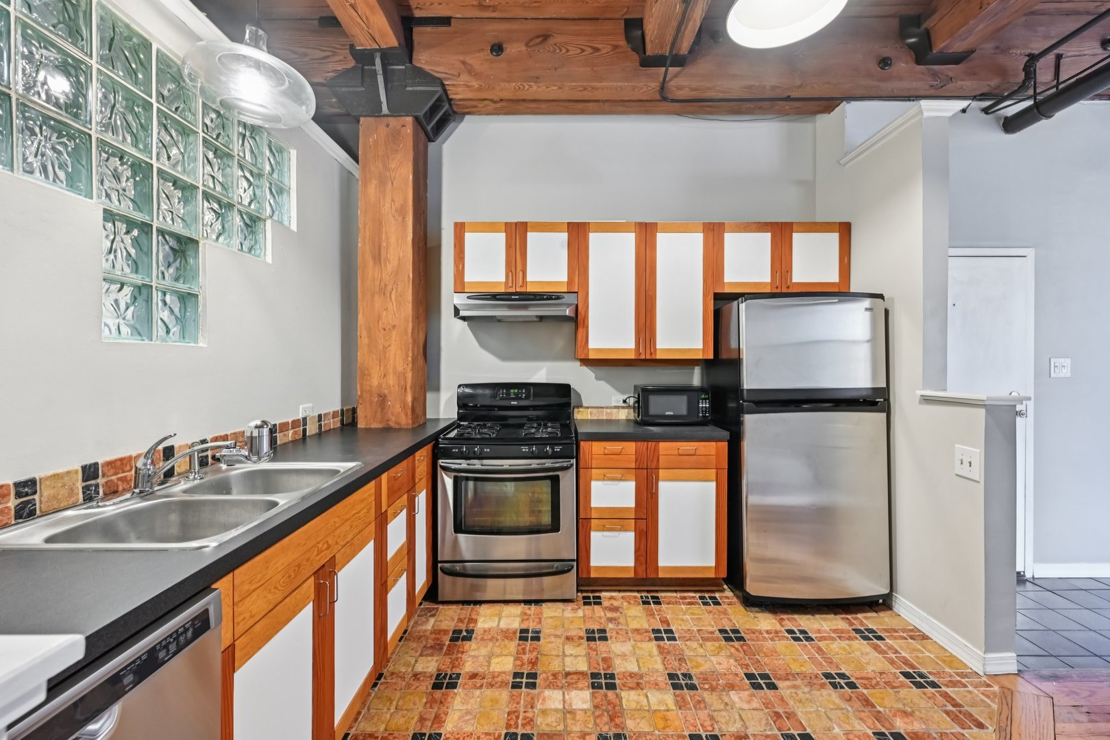 913 West Van Buren Street, Unit 5H Chicago, IL 60607 - Photo 16 of 23 a kitchen with stainless steel appliances granite countertop a sink stove and refrigerator