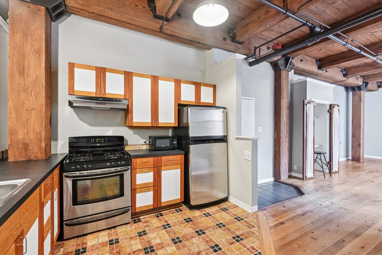 913 West Van Buren Street, Unit 5H Chicago, IL 60607 - Photo 17 of 23 a kitchen with stainless steel appliances granite countertop a stove a refrigerator and a cabinets