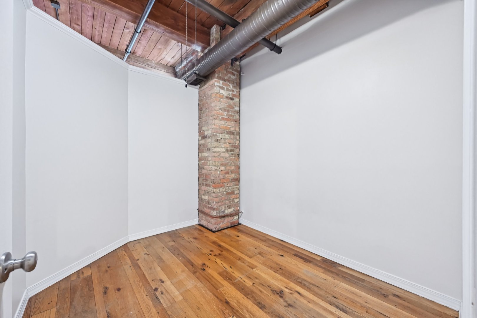 913 West Van Buren Street, Unit 5H Chicago, IL 60607 - Photo 19 of 23 a view of empty room with wooden floor