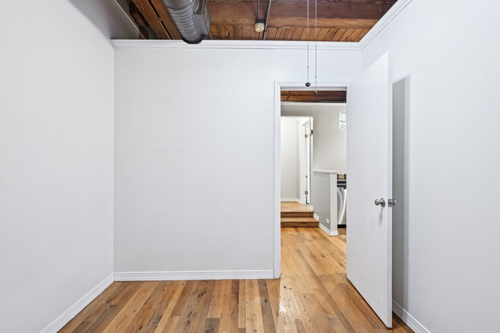 913 West Van Buren Street, Unit 5H Chicago, IL 60607 - Photo 20 of 23 a view of a hallway with wooden floor and a bathroom