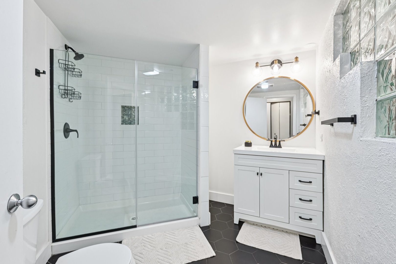 913 West Van Buren Street, Unit 5H Chicago, IL 60607 - Photo 21 of 23 a bathroom with a sink a mirror a vanity and a shower