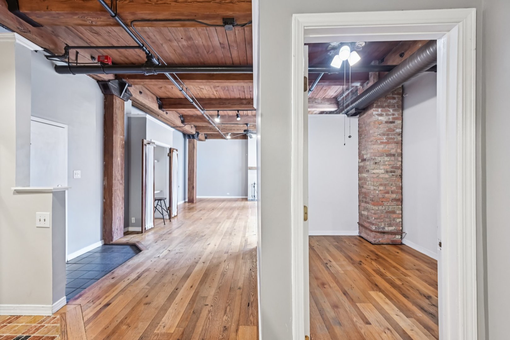 913 West Van Buren Street, Unit 5H Chicago, IL 60607 - Photo 8 of 23 a view of hallway with wooden floor