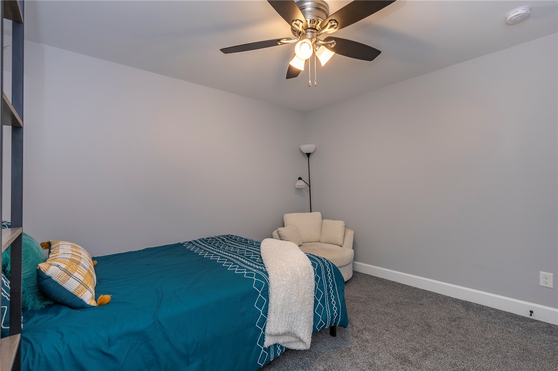 3080 McGee Road Iva, SC 29655 - Photo 20 of 49 A comforting bedroom space features soft gray walls and a plush gray carpet.