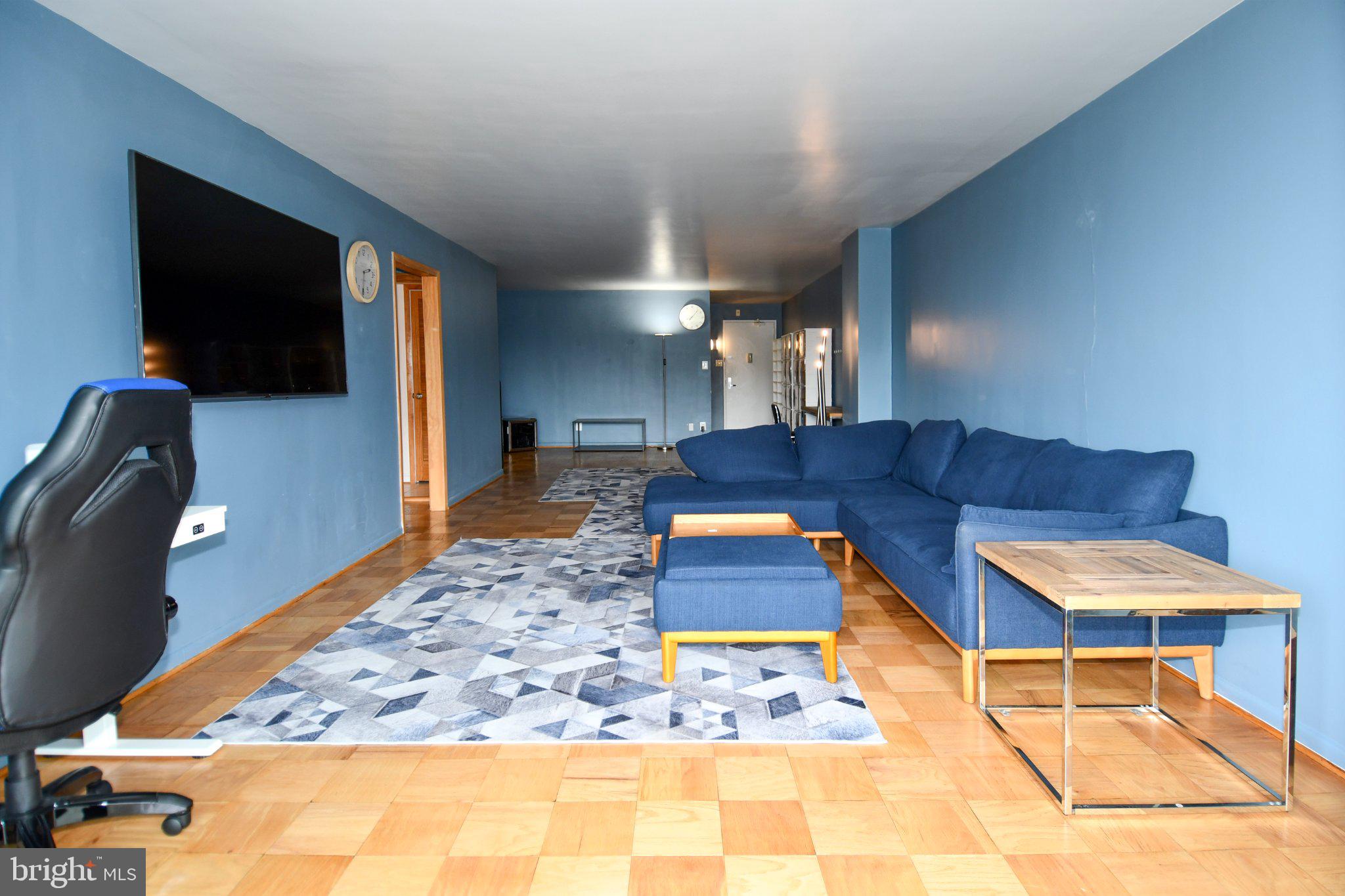 5101 River Road, Unit 712 Bethesda, MD 20816 - Photo 7 of 38 Spacious living area with blue accents.