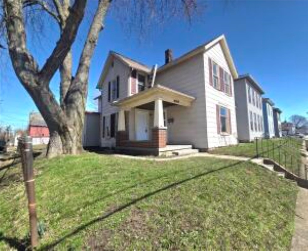 820 West North Street Springfield, OH 45504 - Photo 3 of 20 This charming residence features a welcoming porch and a manicured lawn, ideal for outdoor enjoyment.