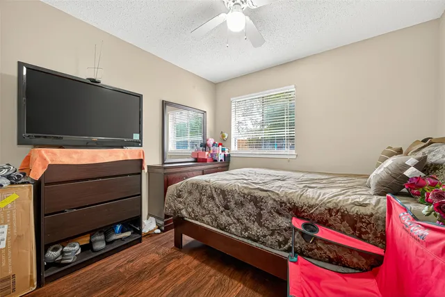 a bedroom with a bed and flat screen tv