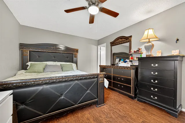 a bedroom with a bed and a dresser in it