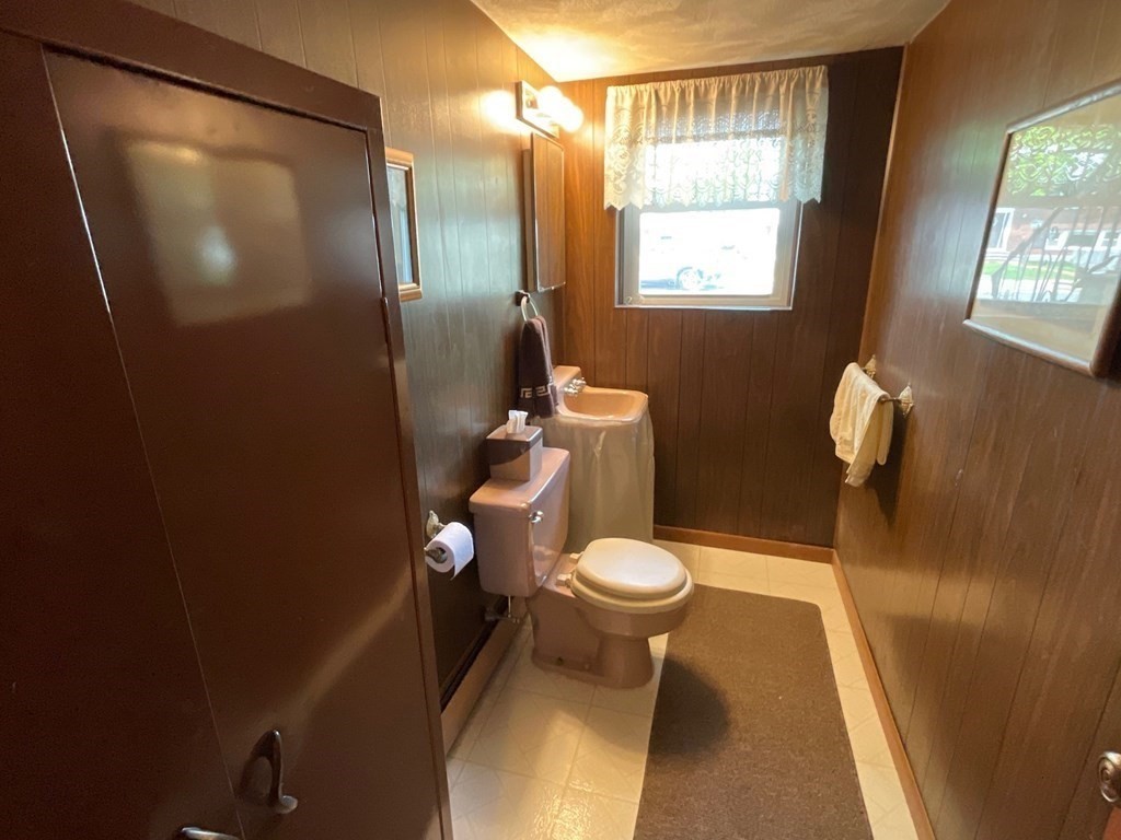 40 Anthony Road Newton, MA 02460 - Photo 12 of 22 a white toilet sitting next to a shower curtain