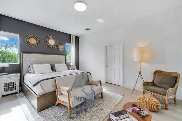 a bedroom with a bed and a chair