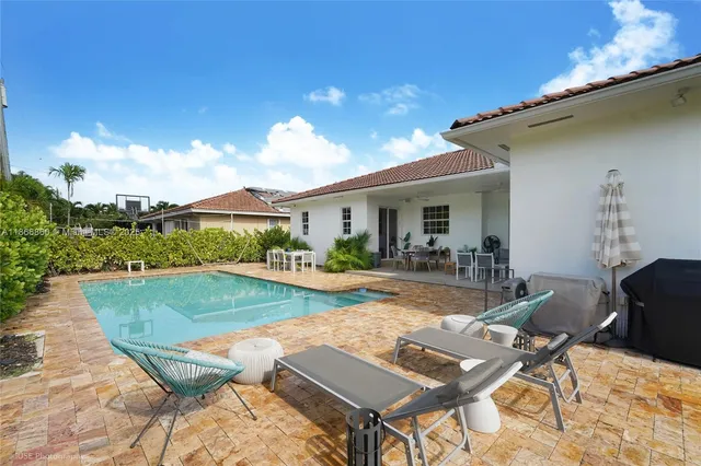 a view of a backyard with furniture