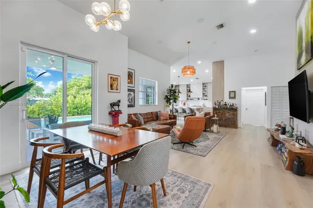 a dining room with furniture and wooden floor