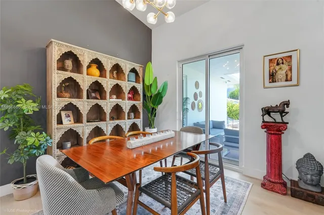a kitchen with a sink and chairs