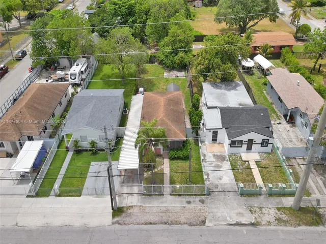 an aerial view of multiple houses with yard