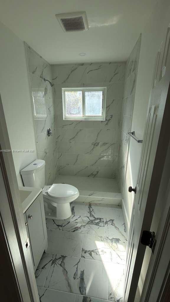 935 Jefferson Avenue, Unit 11 Miami Beach, FL 33139 - Photo 4 of 7 a bathroom with a toilet and a shower