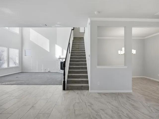a dining room with furniture and chandelier