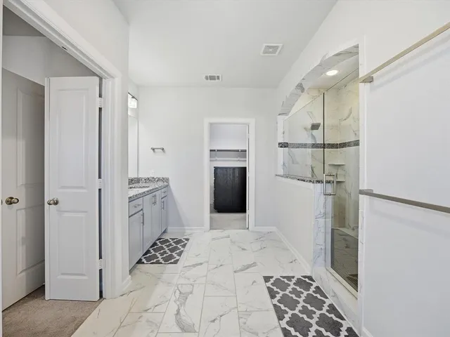 a large bathroom with a sink and a mirror