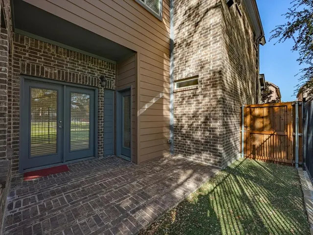 a view of an empty room with a window and cabinet