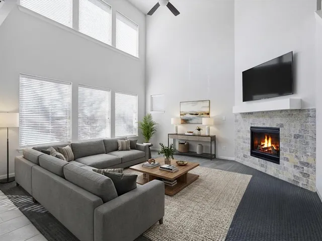 a view of an empty room with a window and chandelier