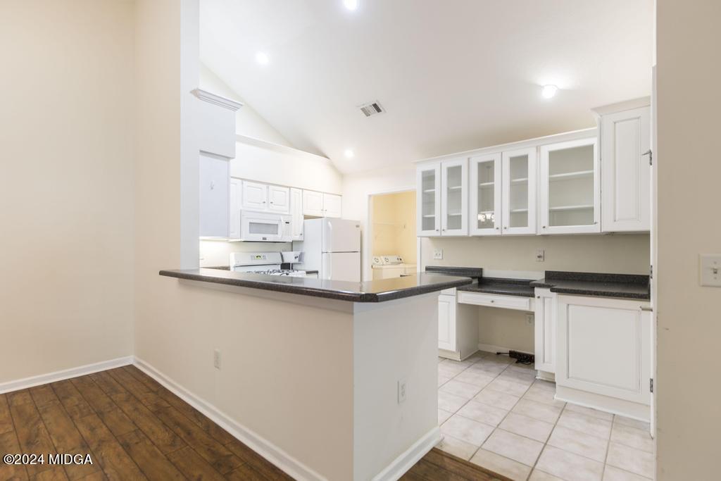 303 Cottage Lane Macon, GA 31210 - Photo 13 of 29 a kitchen with granite countertop a sink stove and cabinets