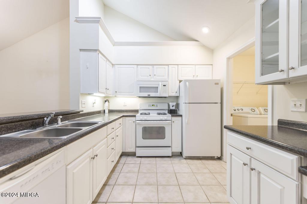 303 Cottage Lane Macon, GA 31210 - Photo 15 of 29 a kitchen with a sink white cabinets and white appliances