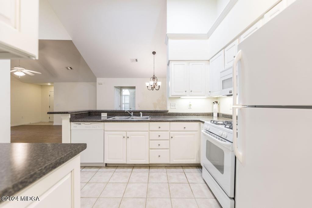 303 Cottage Lane Macon, GA 31210 - Photo 17 of 29 a kitchen with white cabinets appliances and a sink