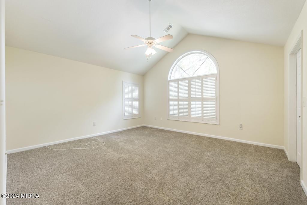 303 Cottage Lane Macon, GA 31210 - Photo 19 of 29 an empty room with windows and chandelier fan