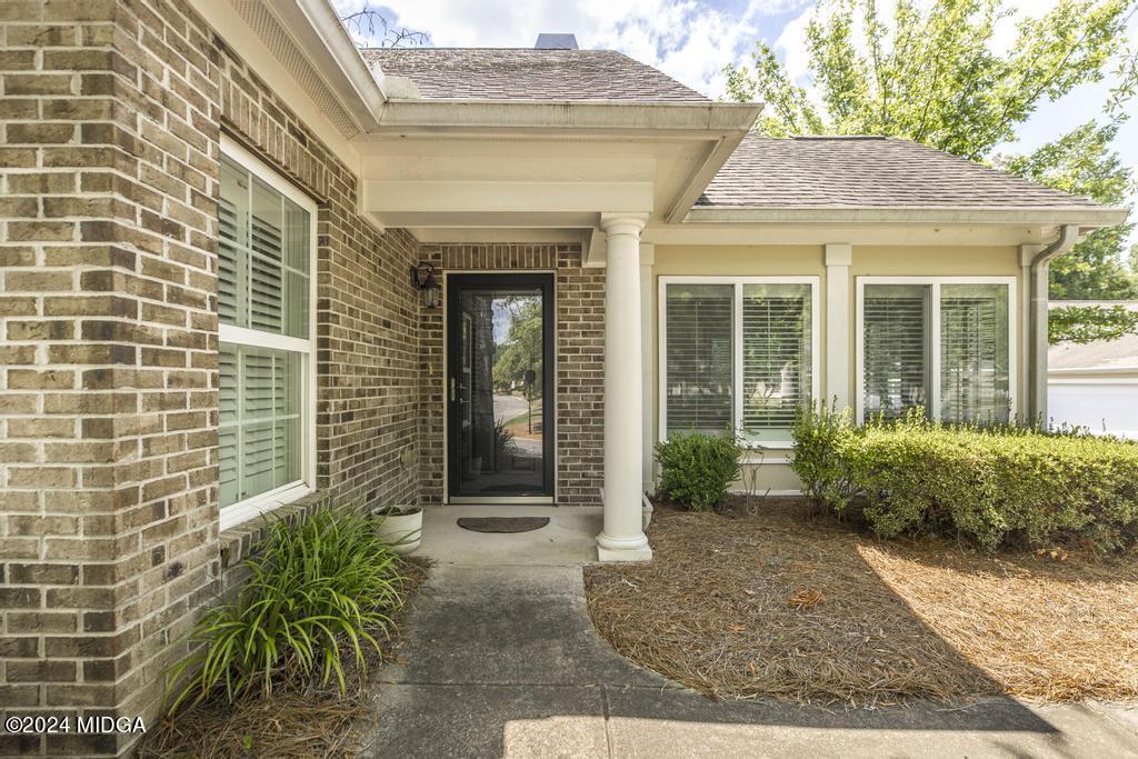 303 Cottage Lane Macon, GA 31210 - Photo 2 of 29 a view of a brick house with potted plants