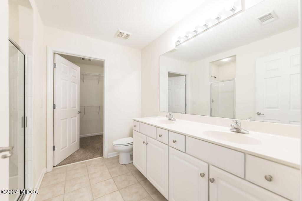 303 Cottage Lane Macon, GA 31210 - Photo 25 of 29 a spacious bathroom with a double vanity sink mirror and toilet
