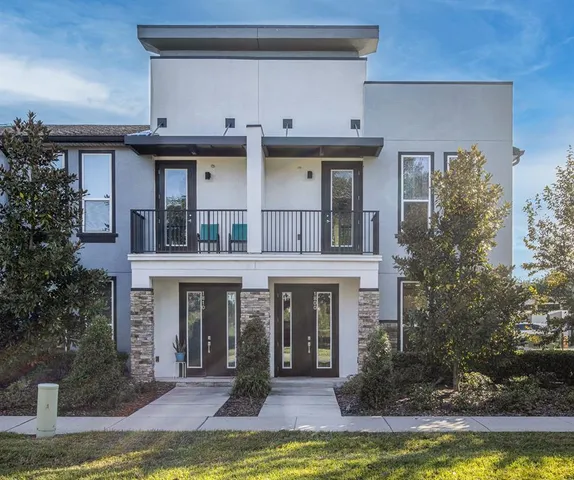 a view of a building with a large window and a yard