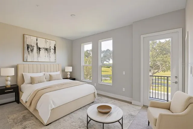 a bedroom with a bed and a couch next to a window