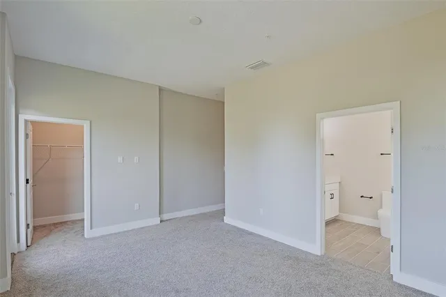 a bedroom with a bed and cabinets