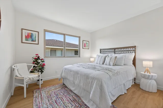 a bedroom with bed and a chair