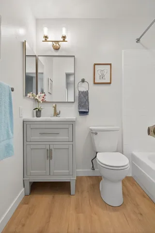 a bathroom with a toilet sink and mirror