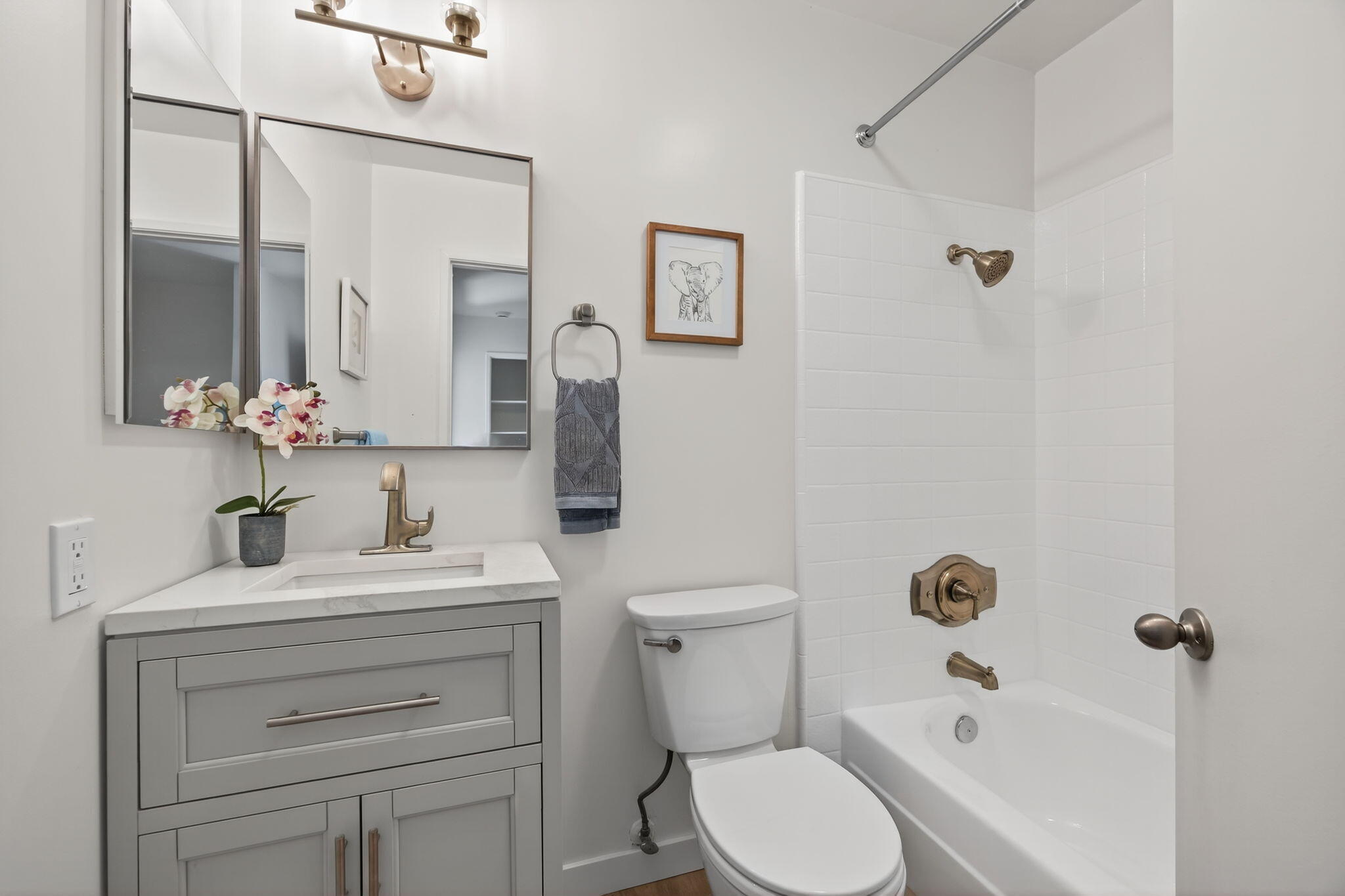 5976 Birch Street, Unit 2 Carpinteria, CA 93013 - Photo 16 of 39 a bathroom with a toilet sink a mirror a vanity and shower