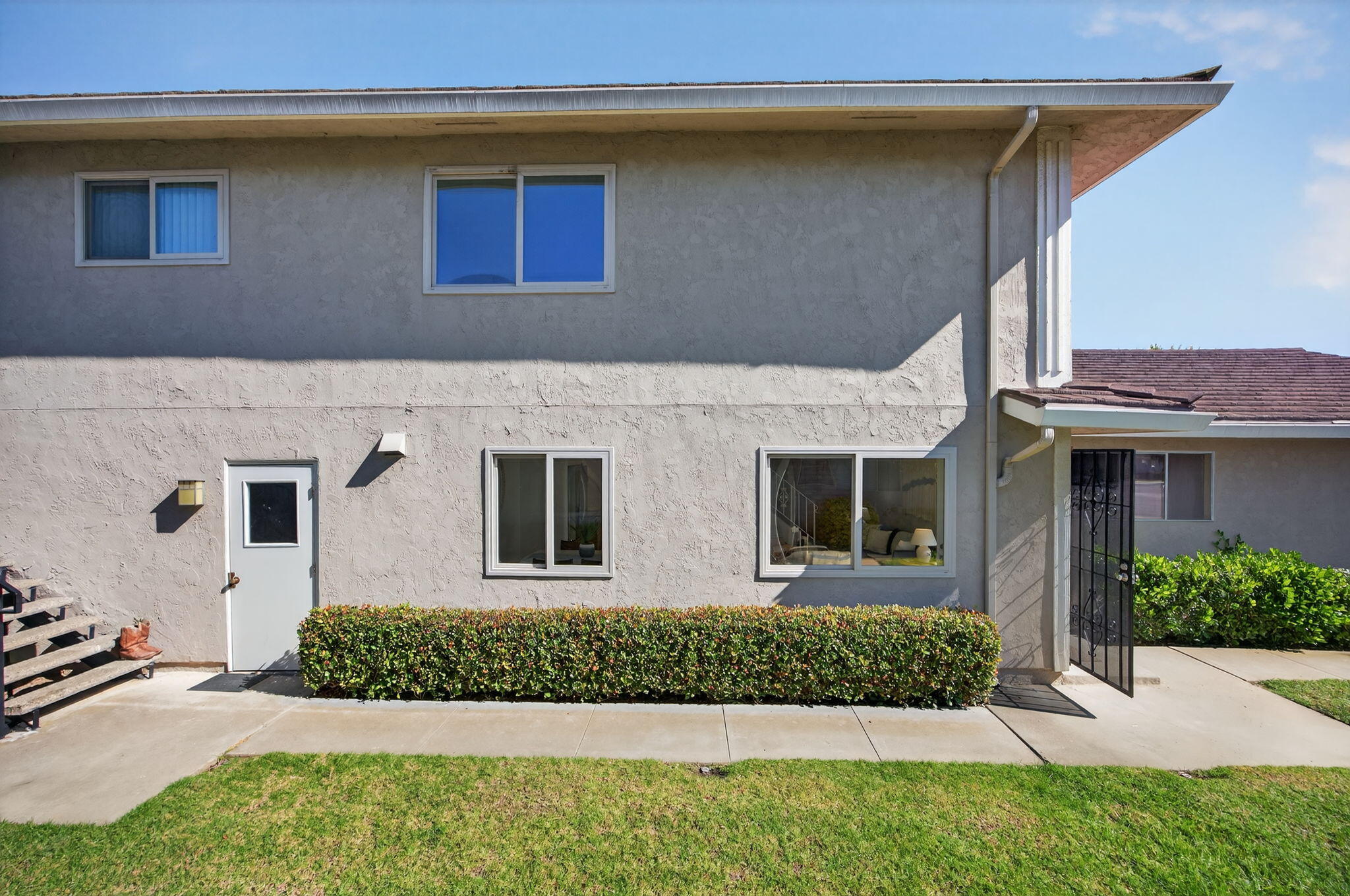 5976 Birch Street, Unit 2 Carpinteria, CA 93013 - Photo 17 of 39 a front view of a house with a yard