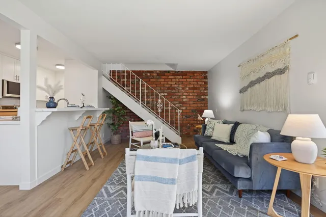 a living room with furniture and a dining table