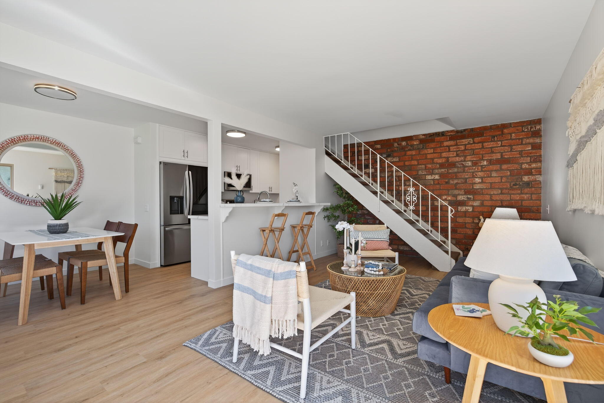 5976 Birch Street, Unit 2 Carpinteria, CA 93013 - Photo 33 of 39 a living room with furniture a wooden floor and a dining table