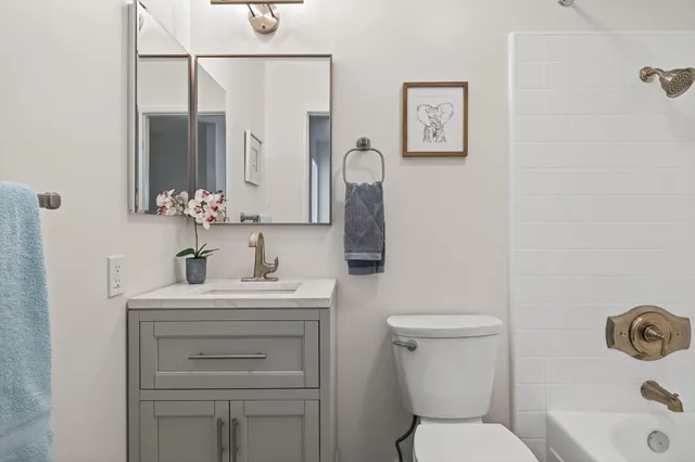 a kitchen with stainless steel appliances a stove a sink and a microwave