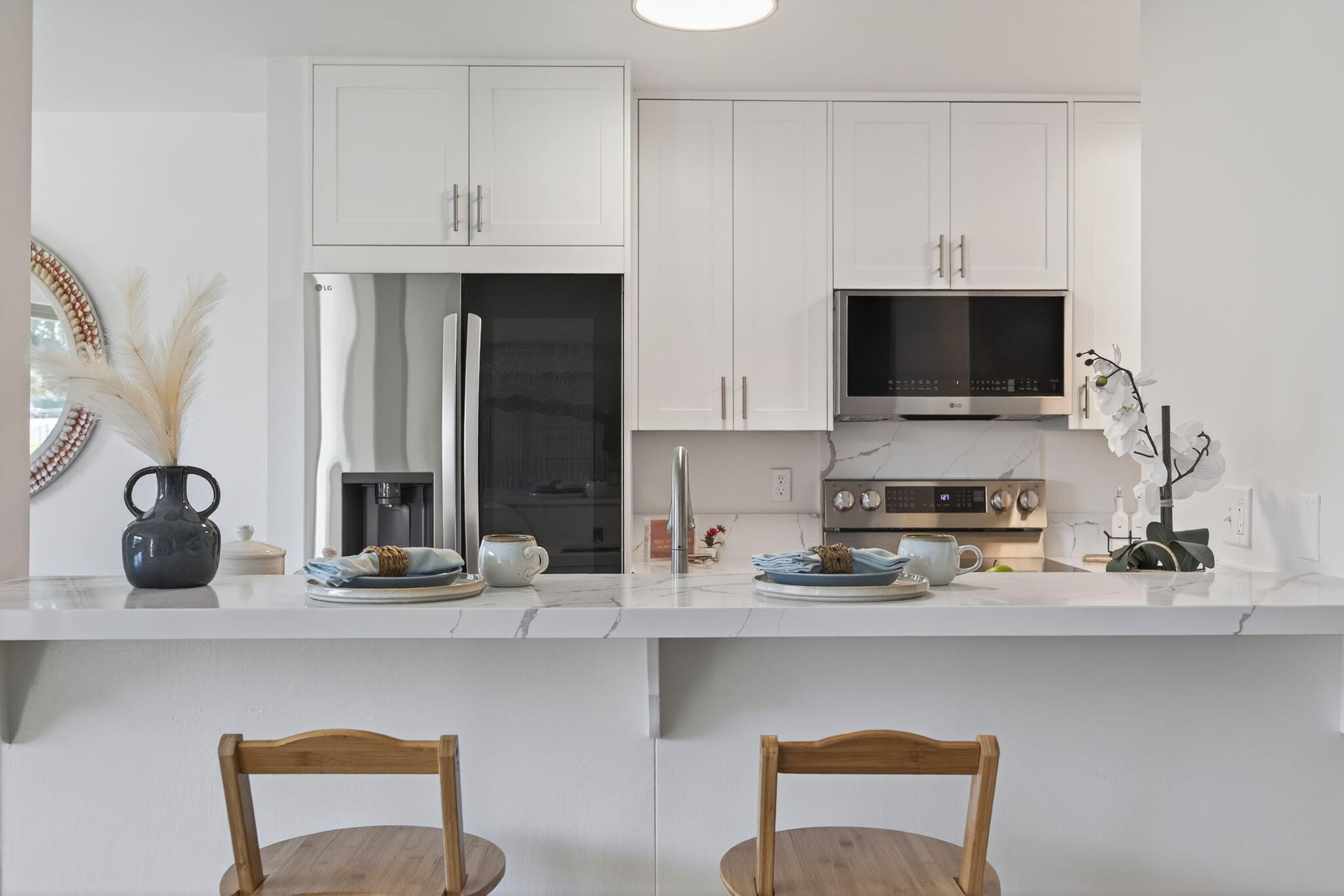 5976 Birch Street, Unit 2 Carpinteria, CA 93013 - Photo 35 of 39 a kitchen with stainless steel appliances a stove a sink and a microwave