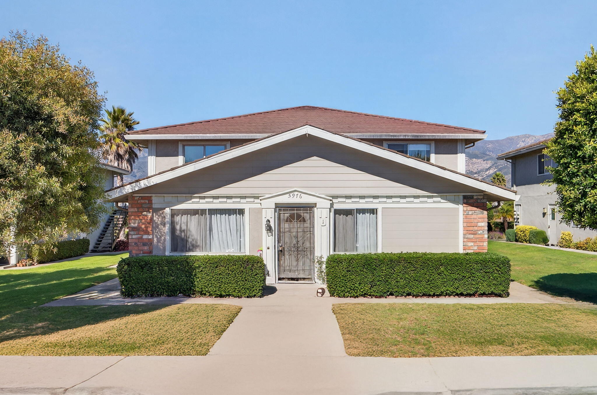 5976 Birch Street, Unit 2 Carpinteria, CA 93013 - Photo 36 of 39 a front view of a house with a yard