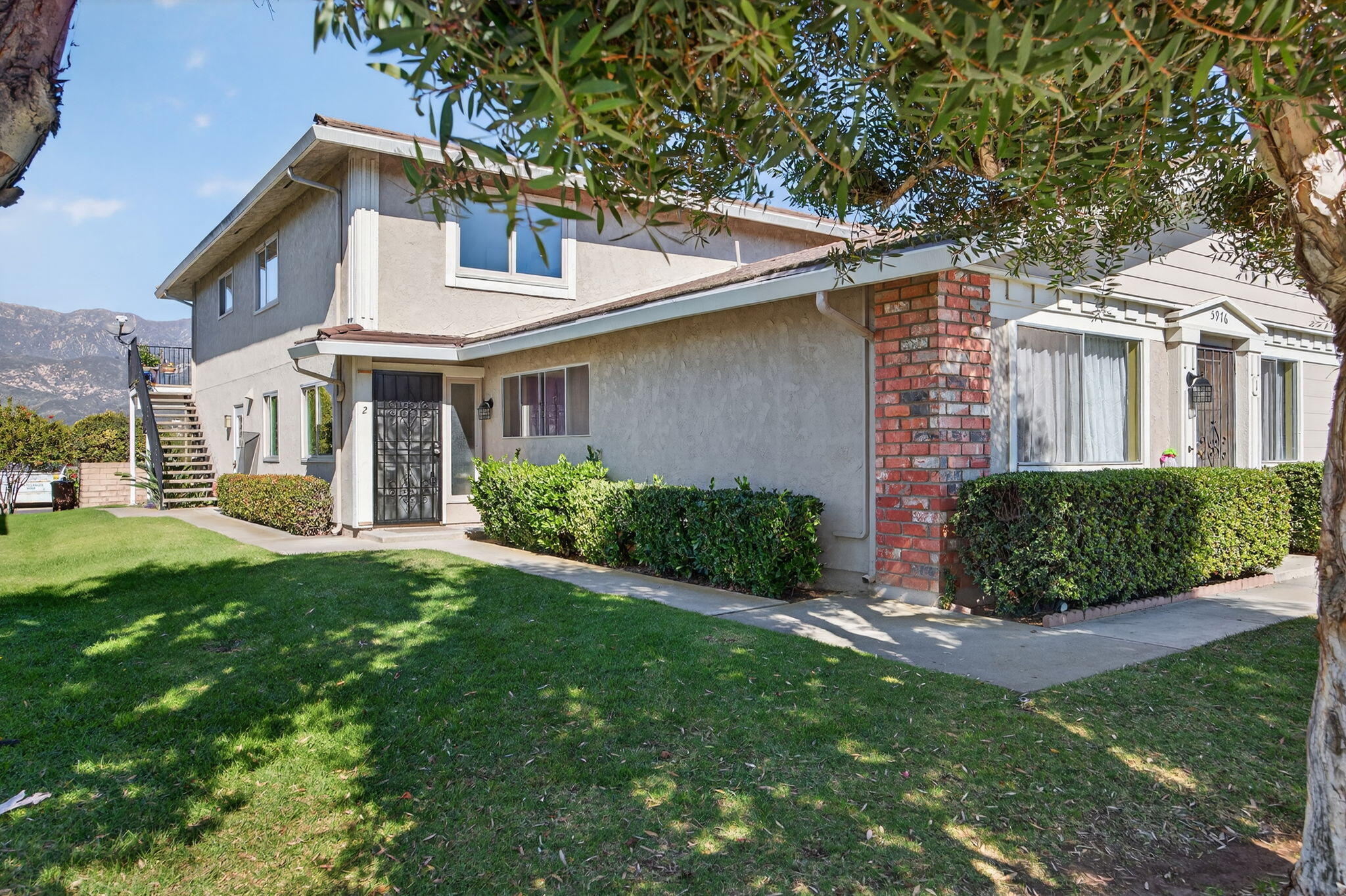 5976 Birch Street, Unit 2 Carpinteria, CA 93013 - Photo 37 of 39 a front view of a house with a yard