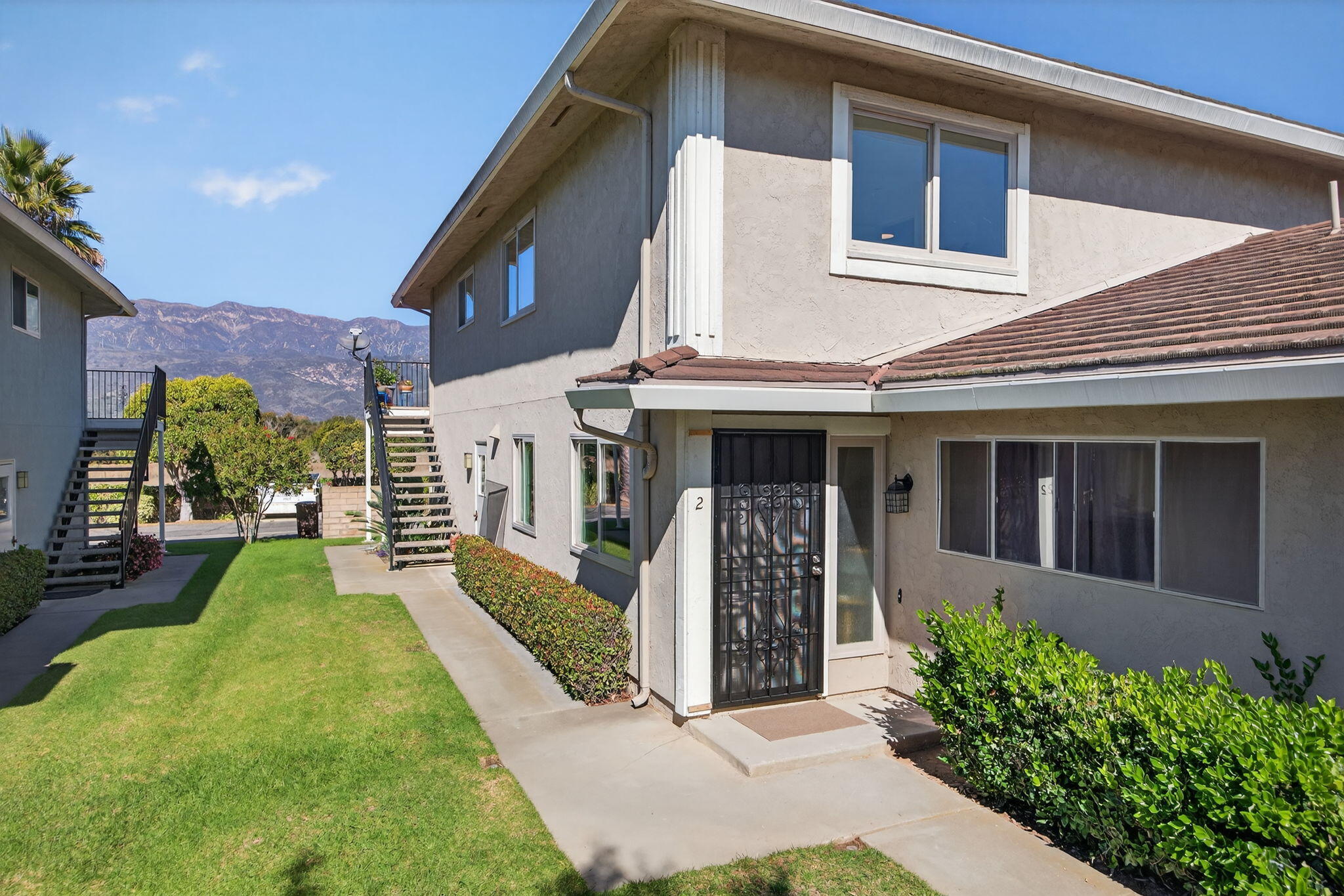 5976 Birch Street, Unit 2 Carpinteria, CA 93013 - Photo 38 of 39 a front view of a house with a yard