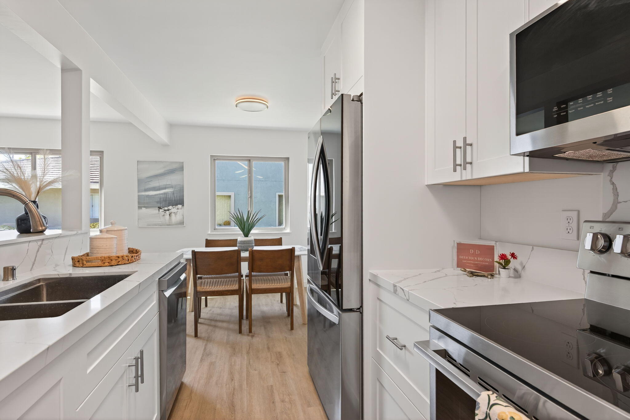 5976 Birch Street, Unit 2 Carpinteria, CA 93013 - Photo 4 of 39 a kitchen with stainless steel appliances a stove a sink and a refrigerator
