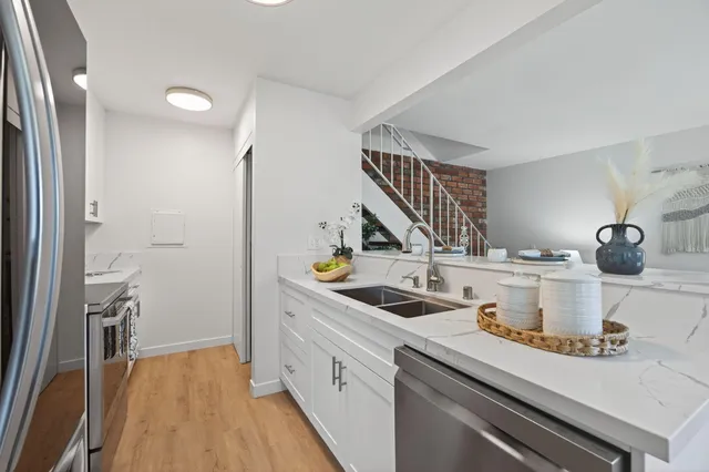 a kitchen with a sink and cabinets